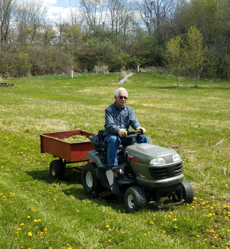 David Rhoads mows the trails along the meadow