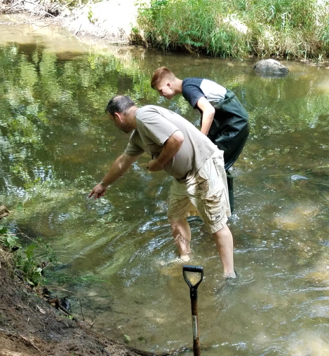 River cleanup volunteers examine the river water